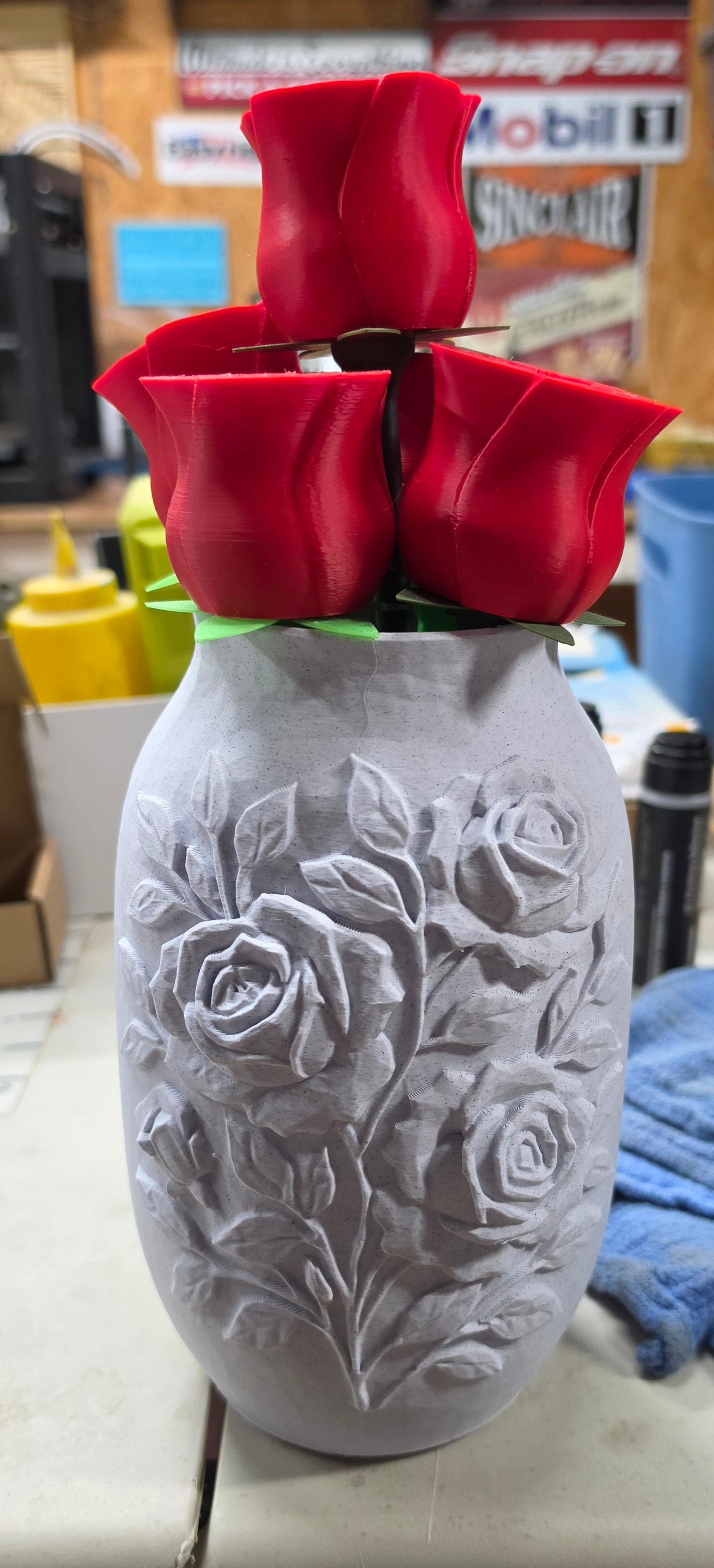 3D printed rose embossed vase with red rose blooms on top