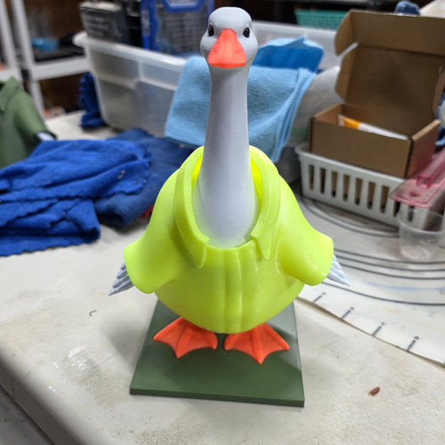 Custom 3D printed desk goose figurine with neon yellow body, white neck, and orange beak and feet